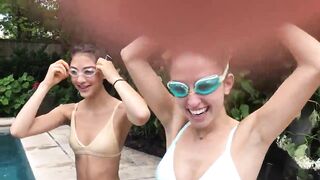 Two Bikini Teens challenging each other in pool