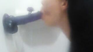 Sucking Purple Dildo in Shower