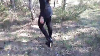 Walking on the wood wearing a black dress pantyhose heels