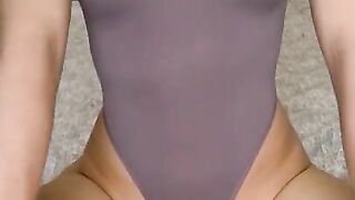 Beautiful Russian blonde in a sexy outfit rubs her wet pussy