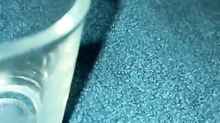 Closeup dripping cum in shot glass slo-mo