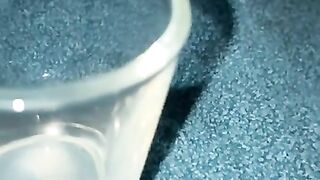 Closeup dripping cum in shot glass slo-mo