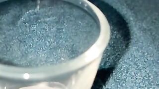 Closeup dripping cum in shot glass slo-mo