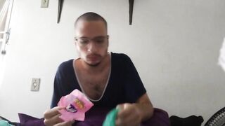 bald man eating pink fini candy