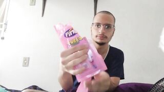 bald man eating pink fini candy