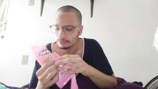 bald man eating pink fini candy