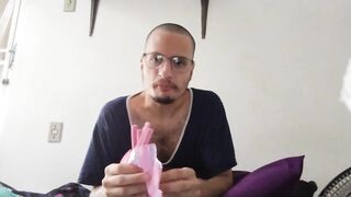 bald man eating pink fini candy