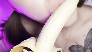 Lucky banana in the mouth of a girl with braces. Eye contact