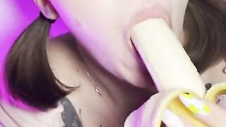 Lucky banana in the mouth of a girl with braces. Eye contact