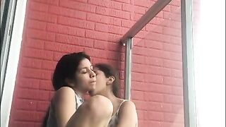 Hot girls film themselves kissing and touching each other on the balcony