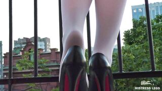 Foot tease in white pantyhose and high heels on the balcony