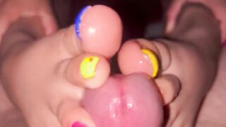 Tickling teasing colourful neon toes rubbing on a big head