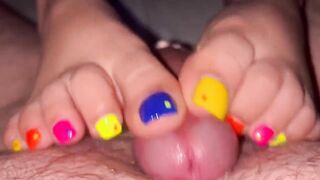 Tickling teasing colourful neon toes rubbing on a big head