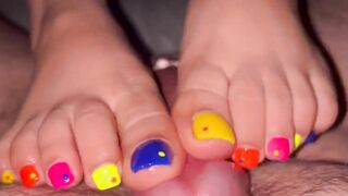 Tickling teasing colourful neon toes rubbing on a big head