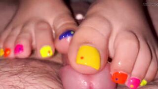 Tickling teasing colourful neon toes rubbing on a big head